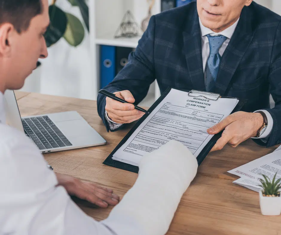 Lawyer offering personal injury legal services in a New York office with a client reviewing documents.